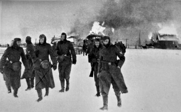 German soldiers abandon a burning Russian village